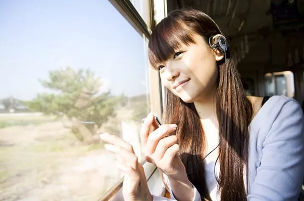 girl-listens-to-music-on-train-billboard-650